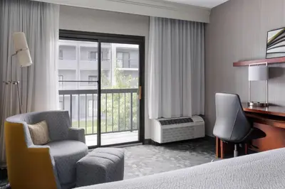 a hotel room with a bed and a desk and chair at Courtyard Philadelphia Willow Grove in Willow Grove
