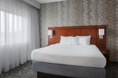 a bedroom with a large bed with white pillows at Courtyard Philadelphia Willow Grove in Willow Grove