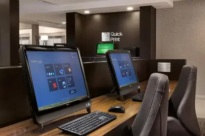 a desk with a computer monitor and a keyboard and mouse at Courtyard Philadelphia Willow Grove in Willow Grove
