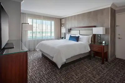 a hotel room with a large bed and a window at Marriott Philadelphia West in West Conshohocken
