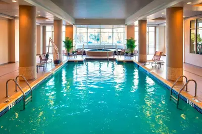 a swimming pool with blue water in a hotel lobby at Marriott Philadelphia West in West Conshohocken