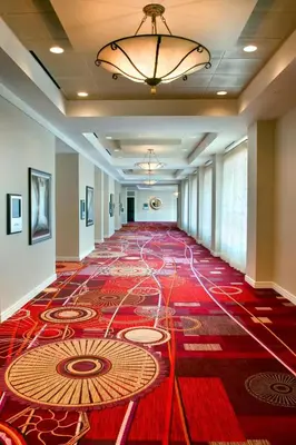 an empty hallway with a large red rug on the floor at Marriott Philadelphia West in West Conshohocken