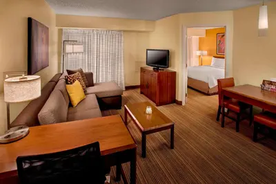 a hotel room with a couch and a bed at Sonesta ES Suites Allentown Bethlehem Airport in Bethlehem