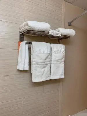 a group of towels on a towel rack in a bathroom at Howard Johnson by Wyndham North Bergen in North Bergen