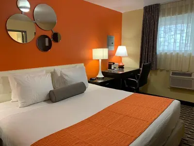 a hotel room with a large bed and a desk at Howard Johnson by Wyndham North Bergen in North Bergen