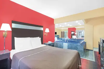 a hotel room with a bed and a bathroom at Howard Johnson by Wyndham North Bergen in North Bergen