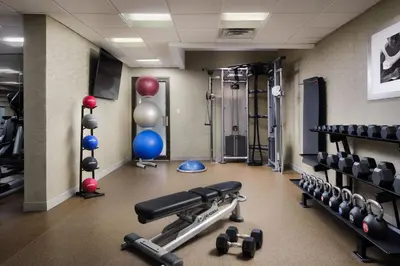 a gym with dumbbells and weights in a room at Marriott Park Ridge in Park Ridge