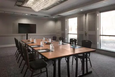 a conference room with a large wooden table and chairs at Marriott Park Ridge in Park Ridge