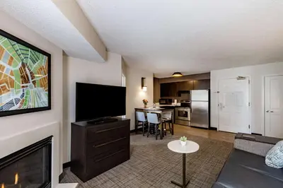 a living room with a flat screen tv next to a fireplace at Sonesta ES Suites Parsippany Morris Plains in Parsippany