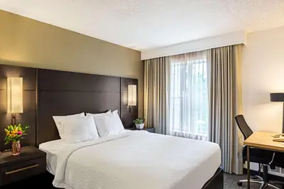 a hotel room with a large bed and a desk at Sonesta ES Suites Parsippany Morris Plains in Parsippany