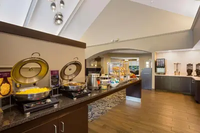 a kitchen with a buffet of food on a counter at Sonesta ES Suites Parsippany Morris Plains in Parsippany