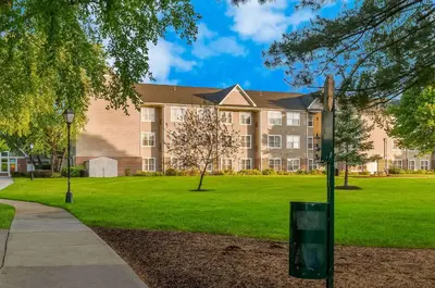 a building with a green lawn in front of it at Sonesta ES Suites Parsippany Morris Plains in Parsippany