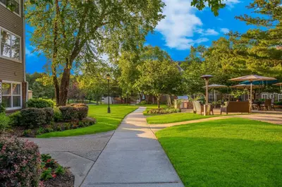 a walkway through a park with chairs and umbrellas at Sonesta ES Suites Parsippany Morris Plains in Parsippany