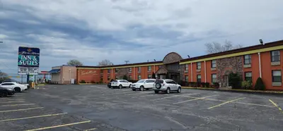 a parking lot with cars parked in front of a building at Town House Inn and Suites in Elmwood Park