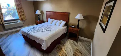 a hotel room with a bed and a window at Town House Inn and Suites in Elmwood Park