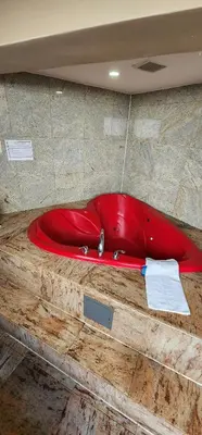 a red bath tub sitting on top of a floor at Town House Inn and Suites in Elmwood Park