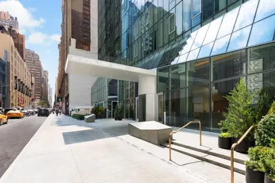a building on a city street with a sidewalk at AC Hotel by Marriott New York Times Square in New York