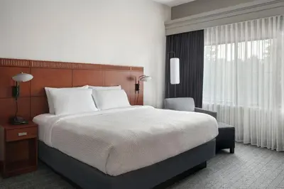 a bedroom with a large bed and a window at Courtyard Philadelphia Plymouth Meeting in Plymouth Meeting