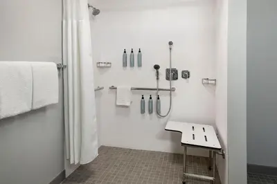 a white bathroom with a shower and a sink at Courtyard Philadelphia Plymouth Meeting in Plymouth Meeting