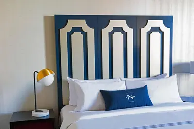 a bed with a blue and white headboard and pillows at The Notary Hotel, Philadelphia, Autograph Collection in Philadelphia