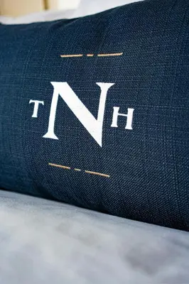 a close up of the tennil logo on a pillow at The Notary Hotel, Philadelphia, Autograph Collection in Philadelphia