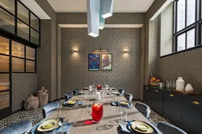 a dining room with a long table and chairs at The Notary Hotel, Philadelphia, Autograph Collection in Philadelphia
