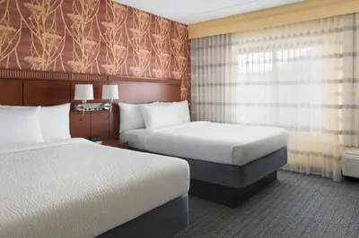 a hotel room with two beds and a window at Courtyard by Marriott Mt. Laurel in Mount Laurel