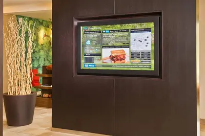 a television on a wall in a room at Courtyard by Marriott Mt. Laurel in Mount Laurel