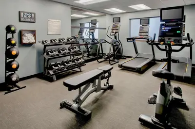 a gym with several treadmills and exercise machines at Courtyard by Marriott Mt. Laurel in Mount Laurel