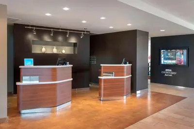 a lobby with a reception desk and a television at Courtyard by Marriott Mt. Laurel in Mount Laurel