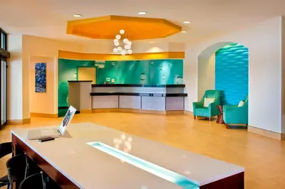 a living room with a table with a laptop on it at SpringHill Suites Philadelphia Plymouth Meeting in Plymouth Meeting