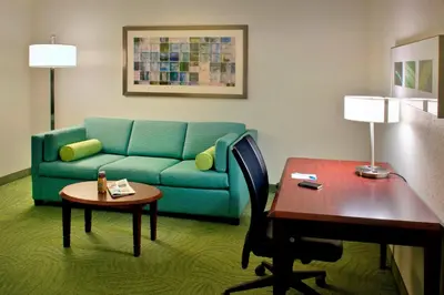 a living room with a couch and a table at SpringHill Suites Philadelphia Plymouth Meeting in Plymouth Meeting