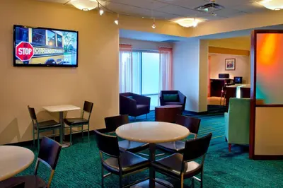 a waiting room with tables and chairs and a stop sign at SpringHill Suites Philadelphia Plymouth Meeting in Plymouth Meeting