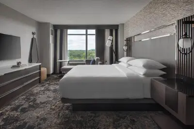 a hotel room with a large bed and a television at Bridgewater Marriott in Bridgewater