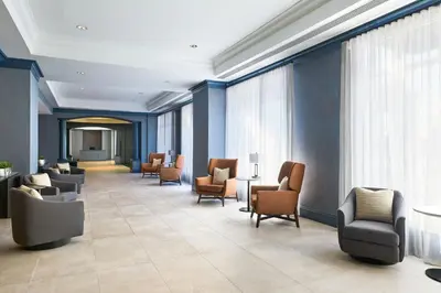 a waiting area in a hospital with chairs and tables at Bridgewater Marriott in Bridgewater