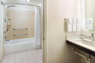 a bathroom with a tub shower and a sink at Residence Inn by Marriott Somerset in Somerset