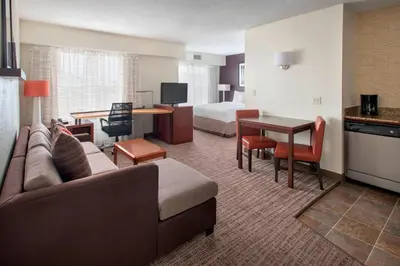 a hotel room with a couch and a bedroom at Residence Inn by Marriott Somerset in Somerset