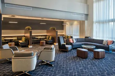 a hotel lobby with couches and tables and chairs at Courtyard by Marriott Basking Ridge in Basking Ridge