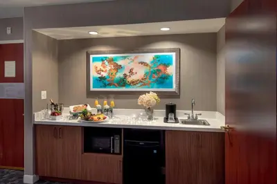a kitchen with a sink and a painting on the wall at Courtyard by Marriott Basking Ridge in Basking Ridge