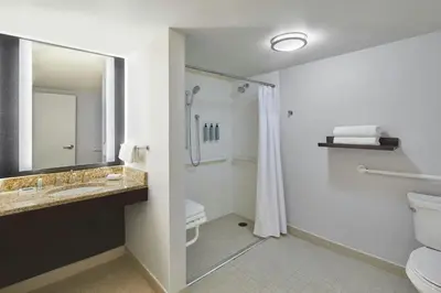 a bathroom with a toilet and a sink and a shower at Courtyard by Marriott Lebanon in Lebanon