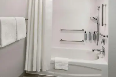a bathroom with a shower and a white shower curtain at Courtyard by Marriott Lebanon in Lebanon
