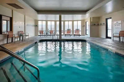 a swimming pool with blue water in a building at Courtyard by Marriott Lebanon in Lebanon