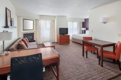 a hotel room with a bed and a living room at Residence Inn Cranbury South Brunswick in Cranbury