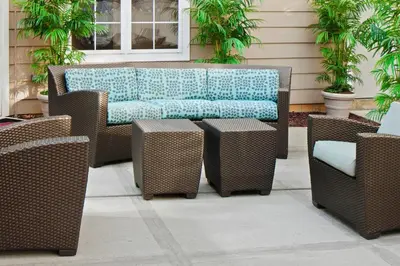 a wicker bench and chairs on a patio at Residence Inn Cranbury South Brunswick in Cranbury
