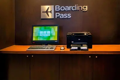 a desk with a computer and a printer on it at Courtyard Wilmington Downtown in Wilmington