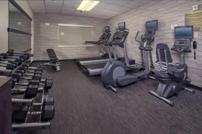 a gym with treadmills and cardio equipment in a room at Sonesta Select Newark Christiana Mall in Newark