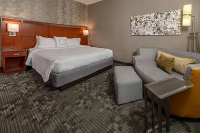 a hotel room with a bed and a couch at Sonesta Select Newark Christiana Mall in Newark