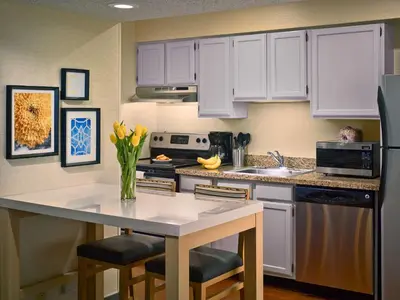a kitchen with white cabinets and a white counter top at Sonesta ES Suites Wilmington - Newark in Newark