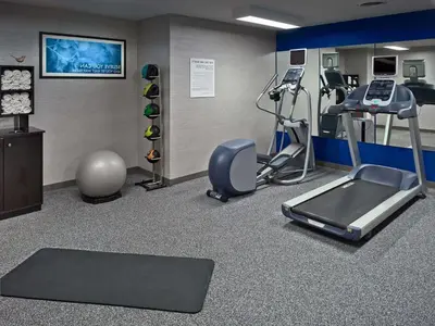 a gym with treadmills and machines in a room at Sonesta ES Suites Wilmington - Newark in Newark