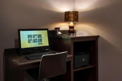 a laptop computer sitting on a desk with a lamp at Residence Inn Philadelphia Valley Forge in Berwyn
